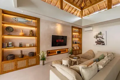 a living room with a couch and a tv at Premium 5 bd Luxury Central Villa 300m to beach & Ku De Ta in Seminyak