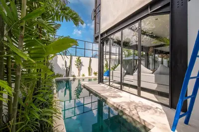 a view of a house with a swimming pool and plants at Villa Vantage Canggu in Canggu
