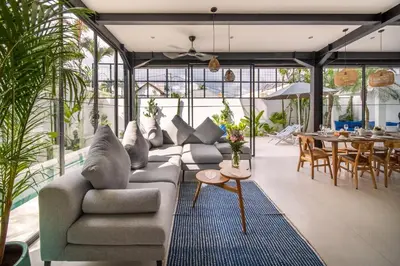 a living room with a couch and a table at Villa Vantage Canggu in Canggu