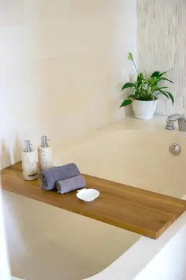a bathroom shelf with a sink and a plant at Villa Suvitha by Villa Finder in Seminyak