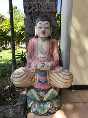 a statue of a buddha sitting on the ground at Largest Villa in Kuta Royal C1 - Turquoise Villa in Kuta