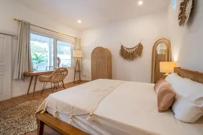 a bedroom with a bed and a desk and a window at Villa Seminyak - 2bdr private big pool villa in Seminyak