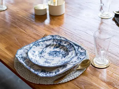 a table with a blue and white plate and a spoon at Villa Seminyak - 2bdr private big pool villa in Seminyak