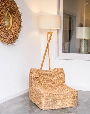 a wicker chair in a living room with a lamp at Villa Seminyak - 2bdr private big pool villa in Seminyak