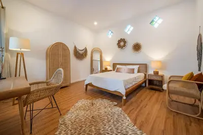 a bedroom with a bed and a living room at Villa Seminyak - 2bdr private big pool villa in Seminyak