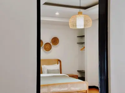 a bedroom with a bed and a pendant light at Villa Sriwedari - Seminyak in Seminyak