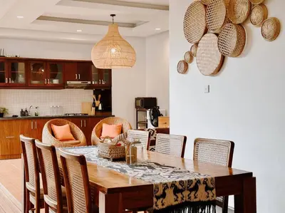a kitchen with a dining room table and chairs at Villa Sriwedari - Seminyak in Seminyak