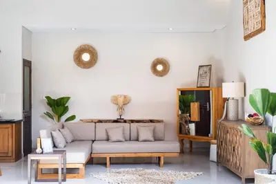 a living room with a couch and a table at [Seminyak central] private 3 bedrooms villa with swimming pool in Seminyak