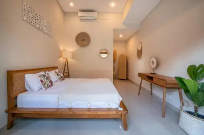 a bedroom with a bed and a desk at [Seminyak central] private 3 bedrooms villa with swimming pool in Seminyak