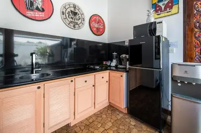 a kitchen with a sink and a refrigerator at Villa Lollie Seminyak in Seminyak