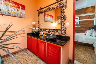 a bathroom with a red vanity and a mirror at Villa Lollie Seminyak in Seminyak