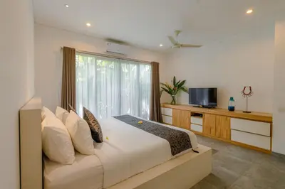 a bedroom with a large bed and a window at Villa Becca Seminyak by Best Deals Asia Hospitality in Seminyak