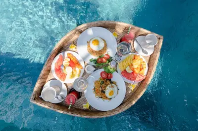 a tray of food on top of a boat in the water at Villa Becca Seminyak by Best Deals Asia Hospitality in Seminyak