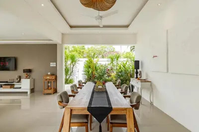 a dining room with a long table and chairs at Fresh and Stylish 3bd Villa in Seminyak with Private Pool in Seminyak