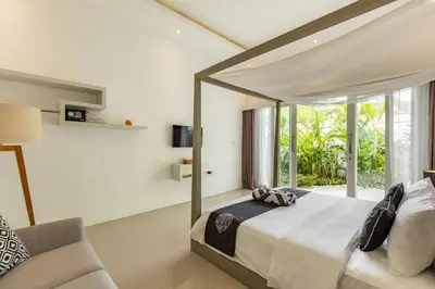 a bedroom with a large bed and a couch at Fresh and Stylish 3bd Villa in Seminyak with Private Pool in Seminyak