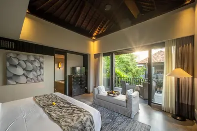 a bedroom with a bed and a living room at Villa De Suma - Fully Staffed Luxury Villa, Central Seminyak, walk to the beach in Seminyak