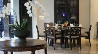 a dining room with a table and chairs at Villa De Suma - Fully Staffed Luxury Villa, Central Seminyak, walk to the beach in Seminyak