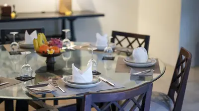 a table with plates and napkins on top at Villa De Suma - Fully Staffed Luxury Villa, Central Seminyak, walk to the beach in Seminyak
