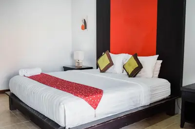 a bedroom with a bed with a red blanket on it at Bali Radiance Villas Seminyak in Seminyak