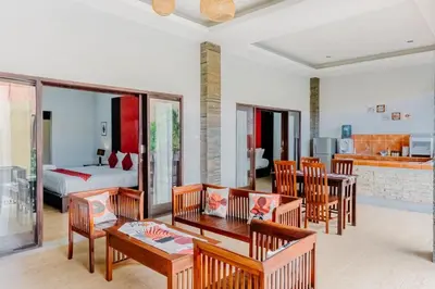 a living room with a table and chairs and a bedroom at Bali Radiance Villas Seminyak in Seminyak