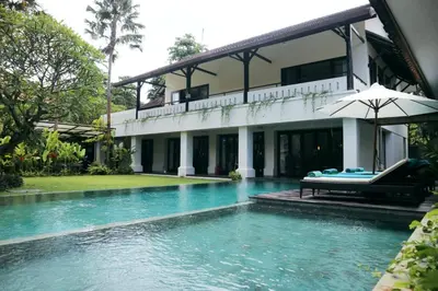 a villa with a swimming pool in front of a house at Villa Mertasari 10C 4 Bedroom with Swimming pool! in Sanur