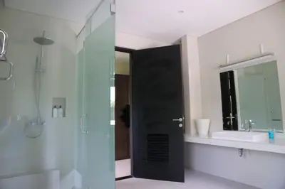 a bathroom with a glass shower and a sink at Villa Mertasari 10C 4 Bedroom with Swimming pool! in Sanur