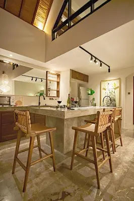 a kitchen with wooden chairs and a large counter at MASARA Villa - 5Min to Canggu - 2Min to Shops & Restaurants in Canggu