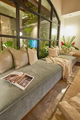 a couch with a magazine on it in a living room at MASARA Villa - 5Min to Canggu - 2Min to Shops & Restaurants in Canggu