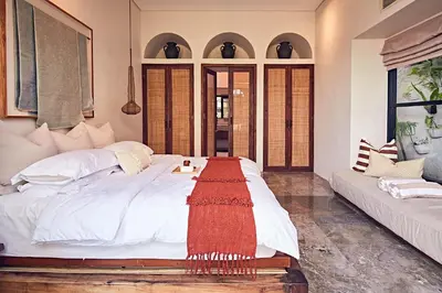 a bedroom with a large white bed and a couch at MASARA Villa - 5Min to Canggu - 2Min to Shops & Restaurants in Canggu