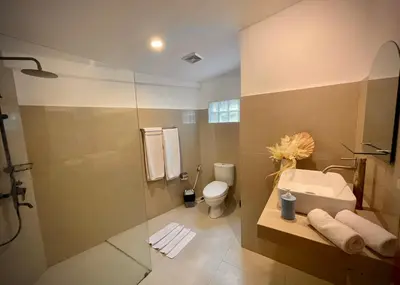 a bathroom with a shower and a sink and a toilet at Villa Majegau 1 Seminyak in Seminyak