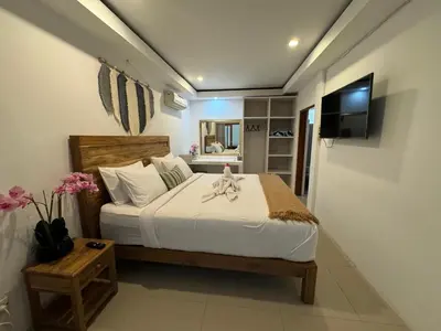 a bedroom with a bed and a television in a room at Villa Majegau 1 Seminyak in Seminyak