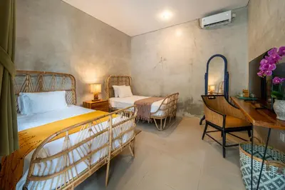 a bedroom with two beds and a desk and a desk at Little Boutique Hotel 106- 30m from beach in Canggu