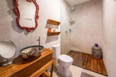 a bathroom with a sink and a toilet and a mirror at Little Boutique Hotel 106- 30m from beach in Canggu