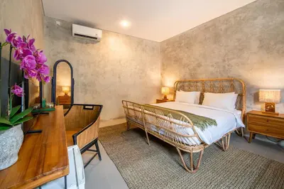 a bedroom with a bed and a table and a desk at Little Boutique Hotel 102 - 30m from beach in Canggu