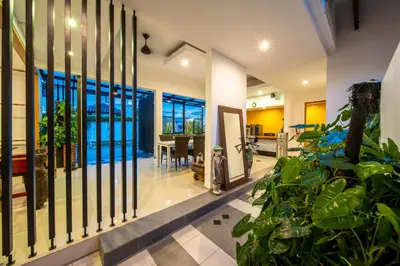 a hallway with plants in a house at Little Boutique Hotel 102 - 30m from beach in Canggu