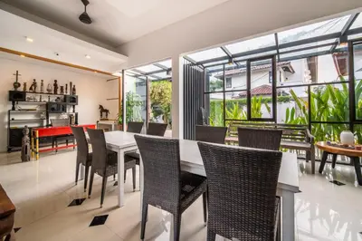 a dining room with a white table and chairs at Little Boutique Hotel 103- 30m from beach in Canggu