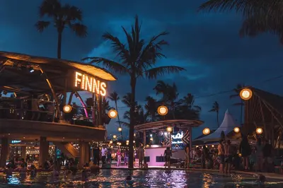 a pool at a theme park at night at Little Boutique Hotel 107- 30m from beach in Canggu
