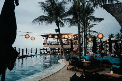 a pool at a resort with people swimming in it at Little Boutique Hotel 107- 30m from beach in Canggu