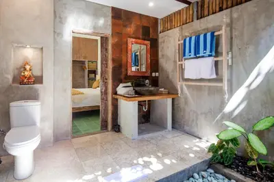 a bathroom with a toilet and a sink at Sunset Paradise Villa Nusa Dua in Nusa Dua