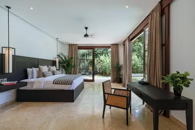 a bedroom with a bed and a desk and a piano at Villa Amara Pradi - 550m to Petitenget Beach in Seminyak