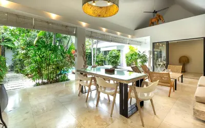 a dining room with a table and chairs at Villa Gallici Seminyak in Seminyak