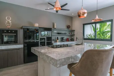 a kitchen with a large marble counter top at Villa Batik - Brand New & Stylish 3BR Villa in Seminyak! in Seminyak