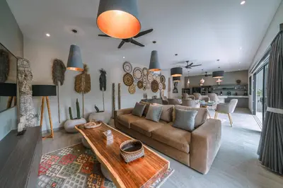 a living room with a couch and a table at Villa Batik - Brand New & Stylish 3BR Villa in Seminyak! in Seminyak
