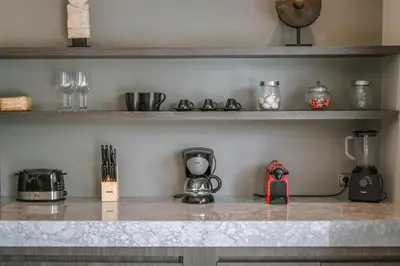 a kitchen counter top with a coffee maker and glasses at Villa Batik - Brand New & Stylish 3BR Villa in Seminyak! in Seminyak