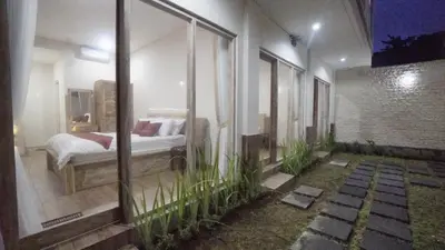 a bedroom with a bed in a room at Maharani Residence in Denpasar