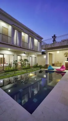 a house with a swimming pool in front of a house at Maharani Residence in Denpasar