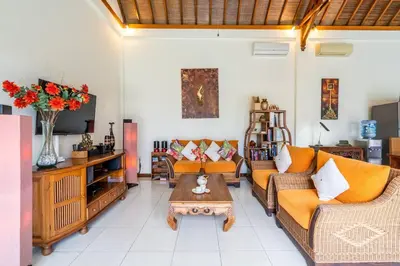 a living room with two couches and a coffee table at Taman Rahasia by iBali Management in Kerobokan