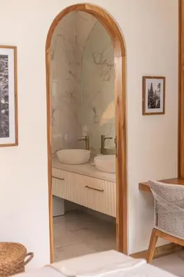 a bathroom with a large mirror and a sink at Villa Kanopi Luxurious 3BR Villa with Pool and Quick Beach Access in Canggu