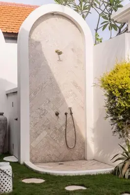 a shower in a wall in a garden at Villa Kanopi Luxurious 3BR Villa with Pool and Quick Beach Access in Canggu