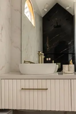 a white bathroom with a sink and a mirror at Villa Kanopi Luxurious 3BR Villa with Pool and Quick Beach Access in Canggu